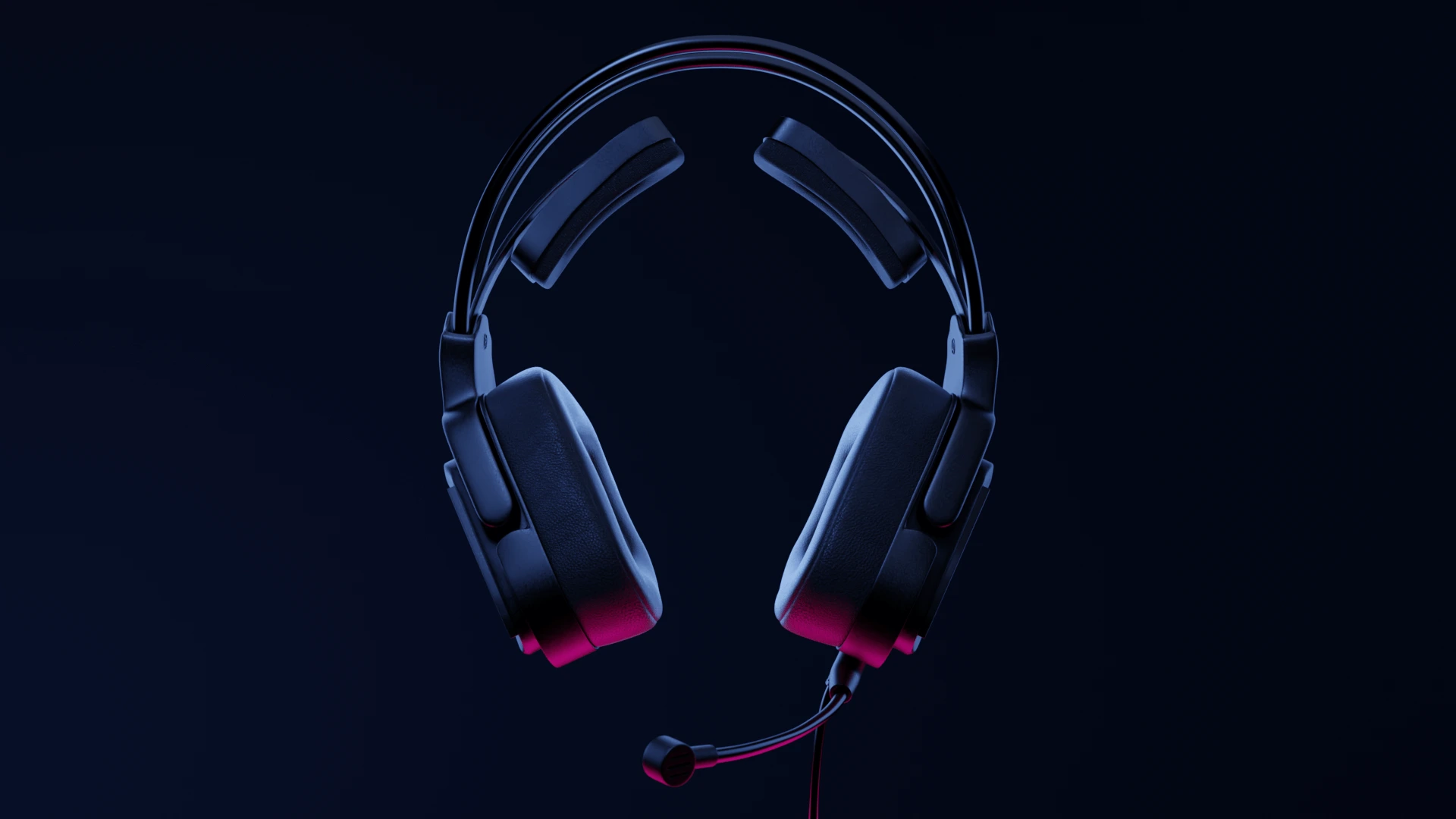 Black overhead headphones with soft ear cushions. The headphones feature a microphone on a flexible stem. They are illuminated with a gradient pink-purple light, standing out against a dark blue background.